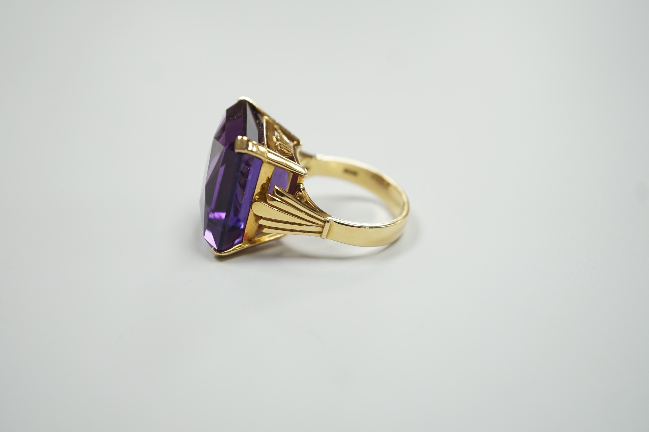 A large modern 18ct gold and fancy rectangular cut single stone amethyst set dress ring, size W, gross weight 22 grams